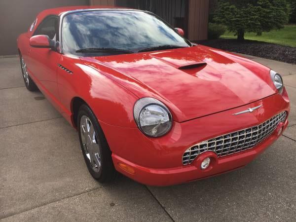 Red Ford Thunderbird with a glossy hood